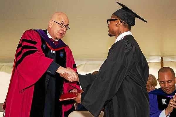 Bard College president Leon Botstein shaking the hand of a graduating BPI student at the commencement ceremony.