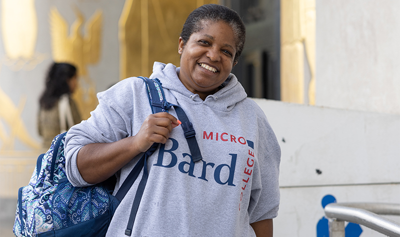 Microcollege student smiling outside the Brooklyn Public Library