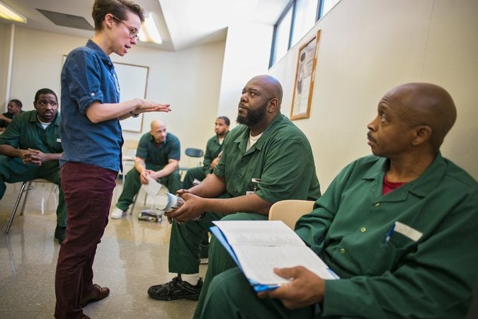 A program coordinator from the Prison Reentry Institute at John Jay College discusses college opportunities with incarcerated men at the Queensboro Correctional Facility.