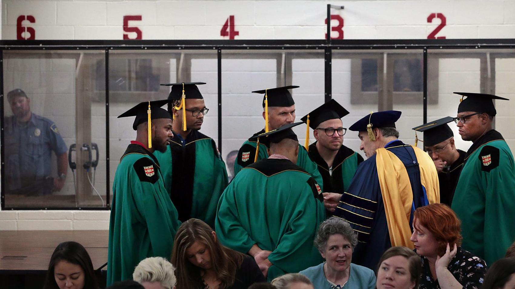 Graduates of Washington University's Prison Education Project speak with its director, Robert K. Henke, in front of the visitation bays at the Missouri Eastern Correctional Center in Pacific before ten inmates received associate degrees on Wednesday, May 22, 2019.