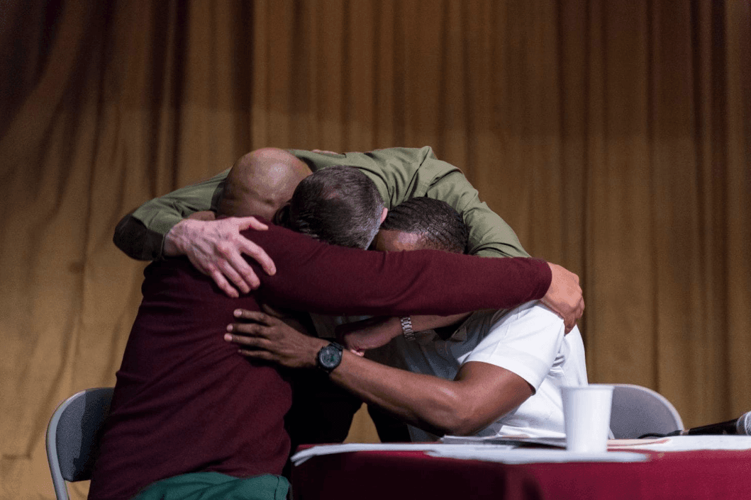 The Bard Prison Initiative team hugs in reaction to defeating Cambridge.