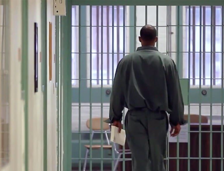 Student walking through prison hall.