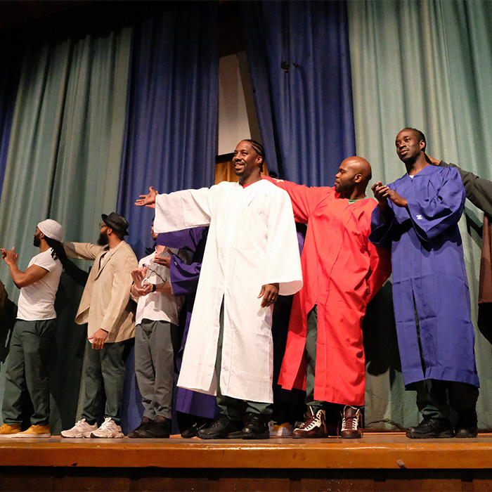 BPI Student actors in robe costumes are applauded at end of A Passing Life.