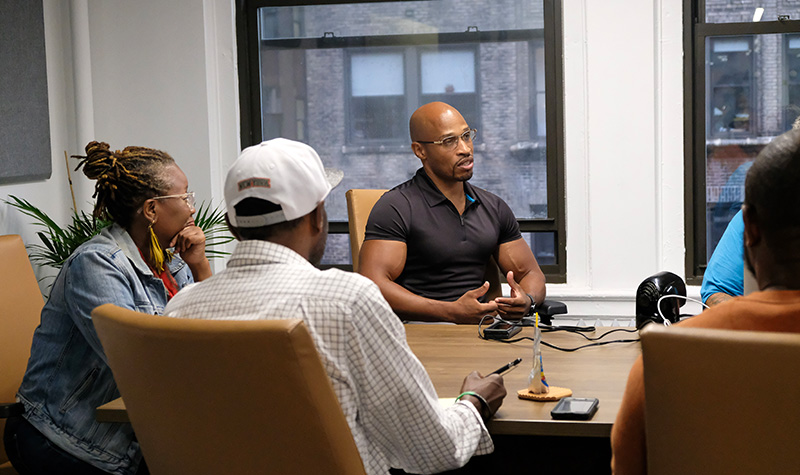 People gathered around a table at the BPI office.