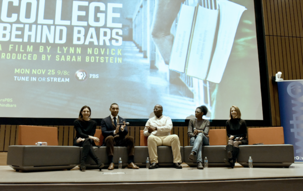 Panelists sitting on stage 