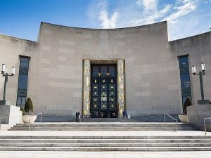 The Brooklyn Public Library building against a bright blue sky.