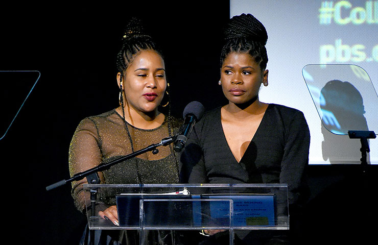 Shawnta Montgomery and Elitha Smith-Lutz speaking on stage.