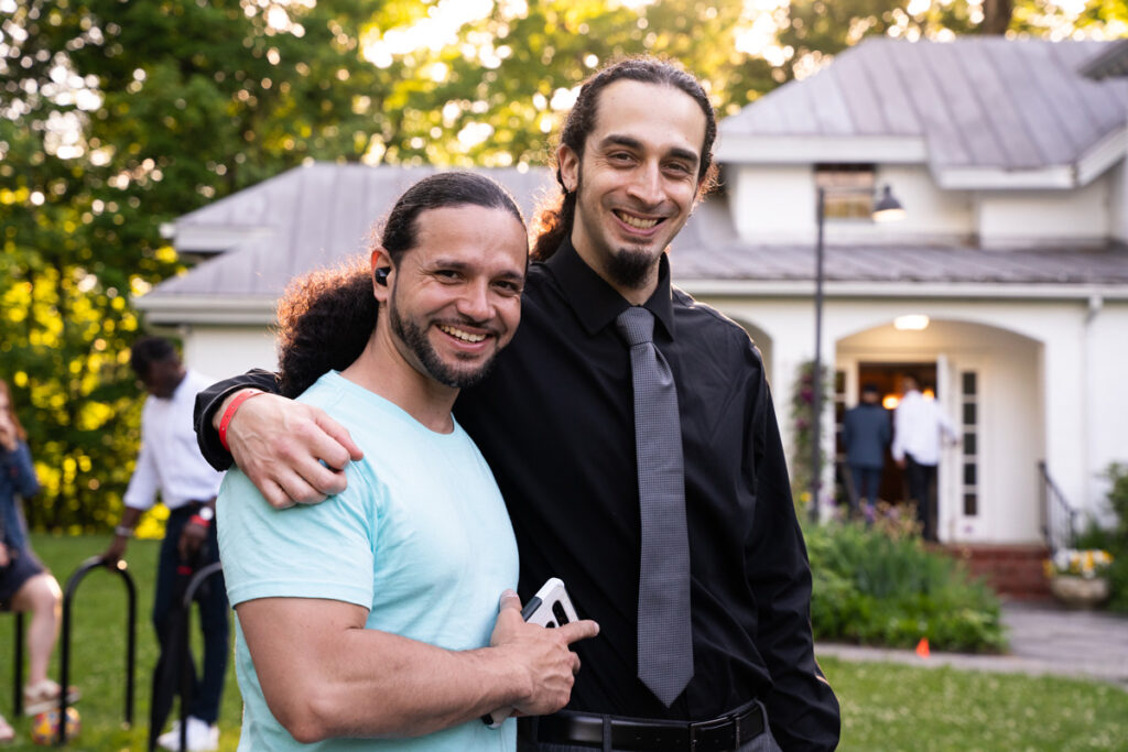 Two alumni smiling and posing at Bard's Annandale campus.