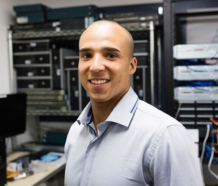 Alumni in a room with servers.