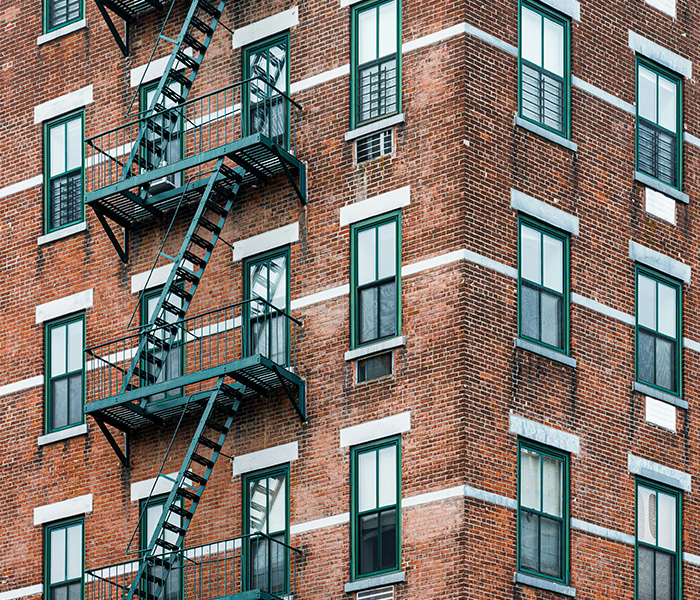 Exterior of an apartment building with fire escape.