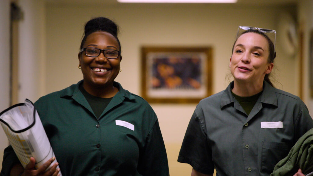 Two BPI students chatting as they walk down the hall.