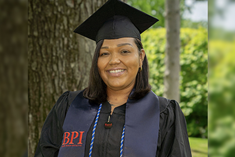 BPI alumna wearing cap and gown
